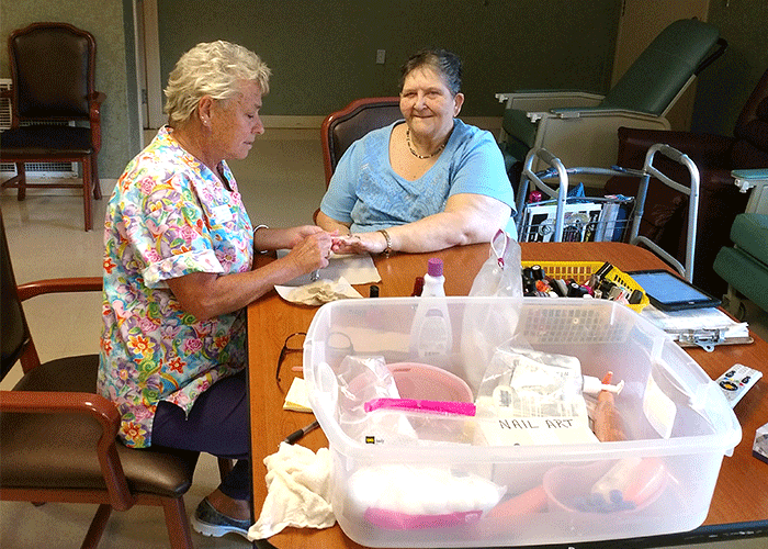 Staff member painting a resident's nails for Spa Day